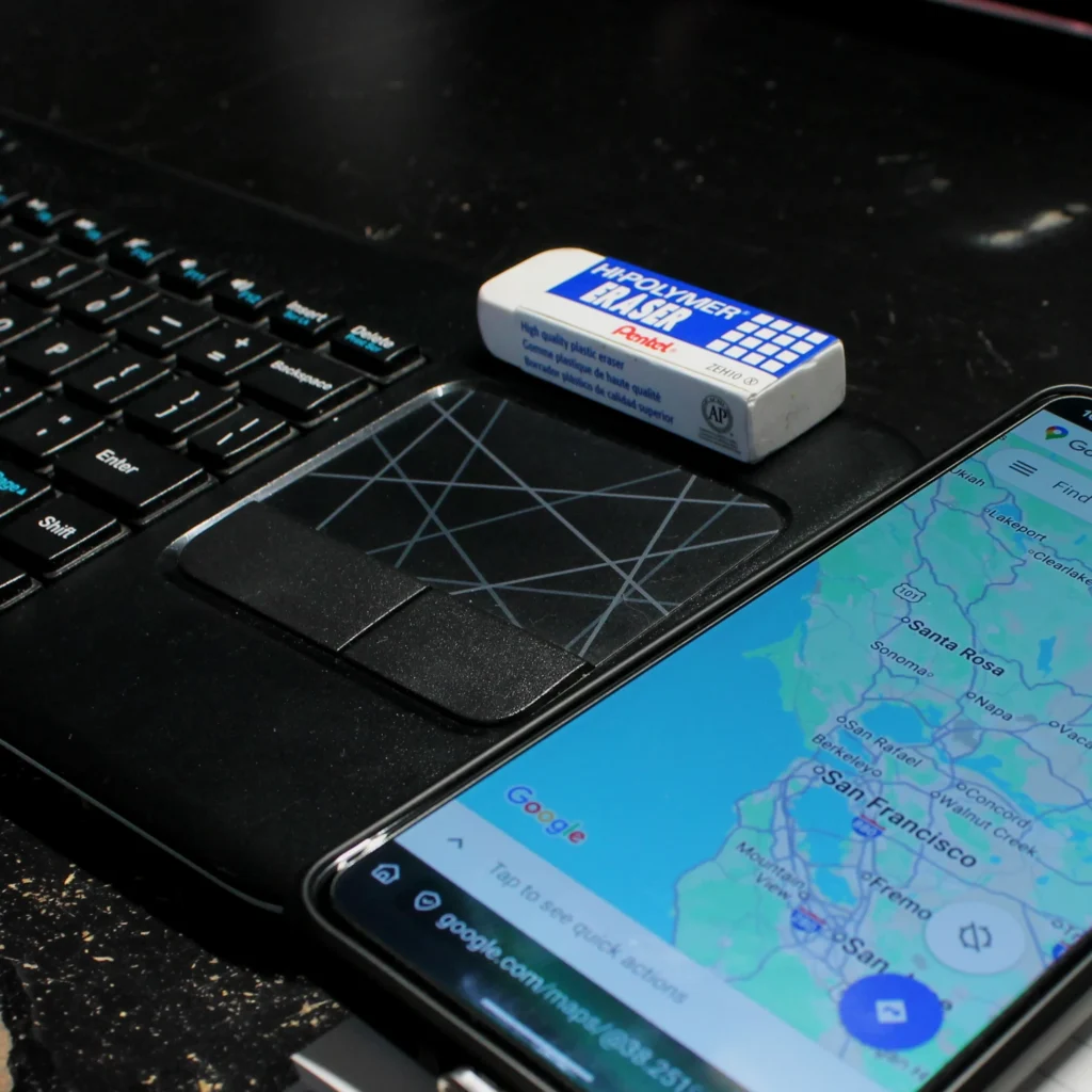 Google Maps opened on a phone sitting next to a keyboard.